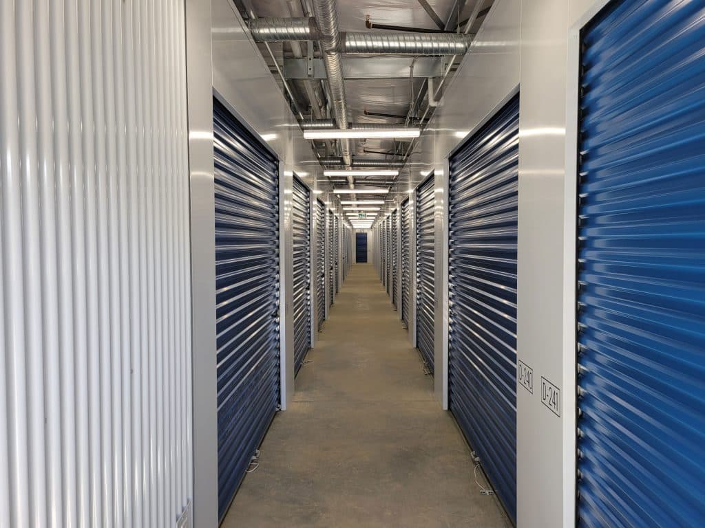 Well-lit interior hallway with secure storage units at All Access Storage Parksville.