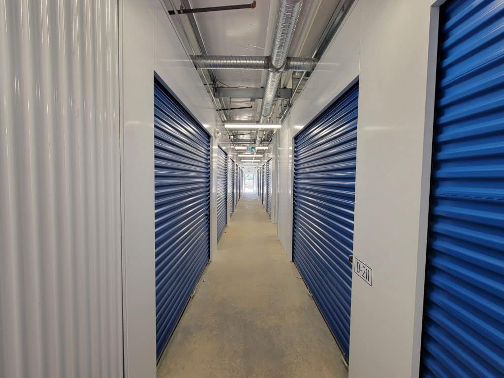 Well-lit interior hallway with secure storage units at All Access Storage Parksville.