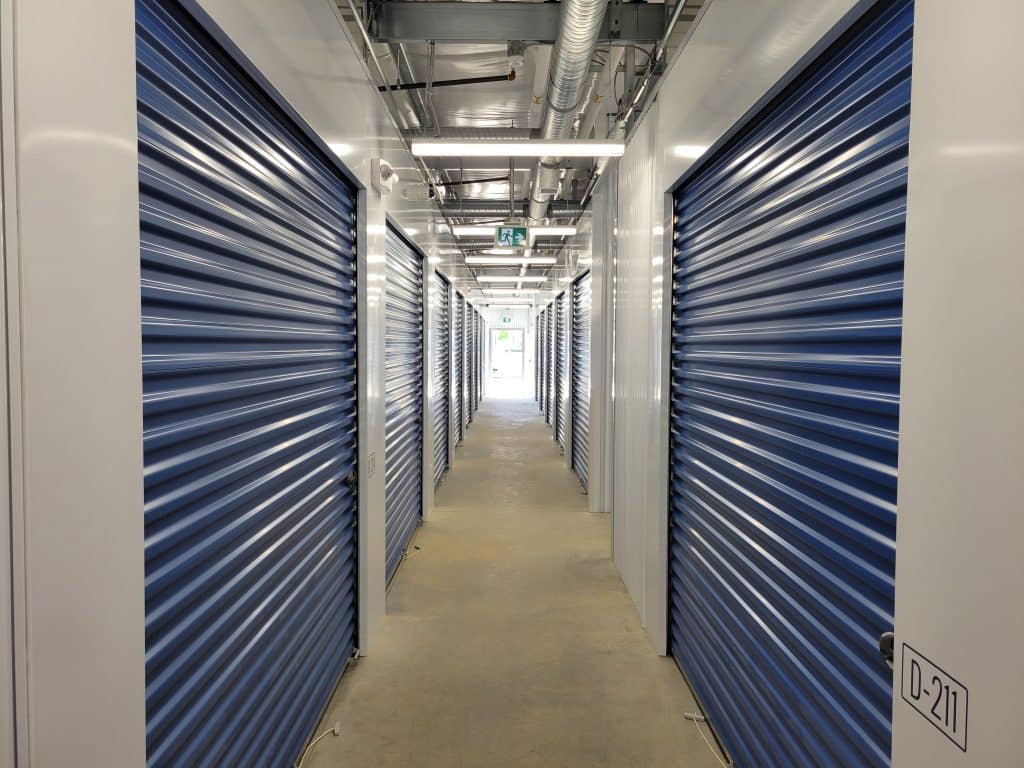 Well-lit interior hallway with secure storage units at All Access Storage Parksville