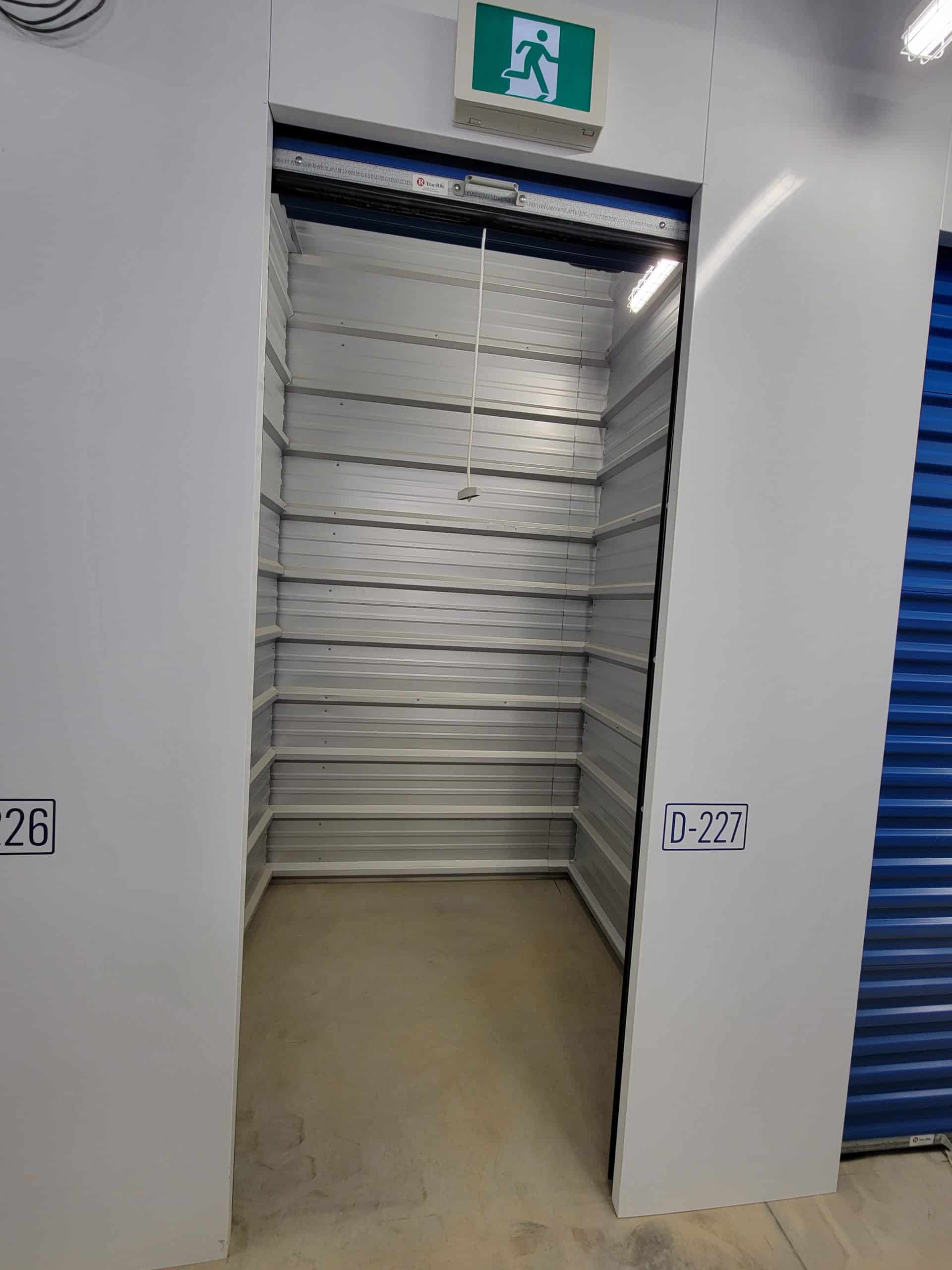 Clean, empty storage unit with roll-up door at All Access Storage Parksville.