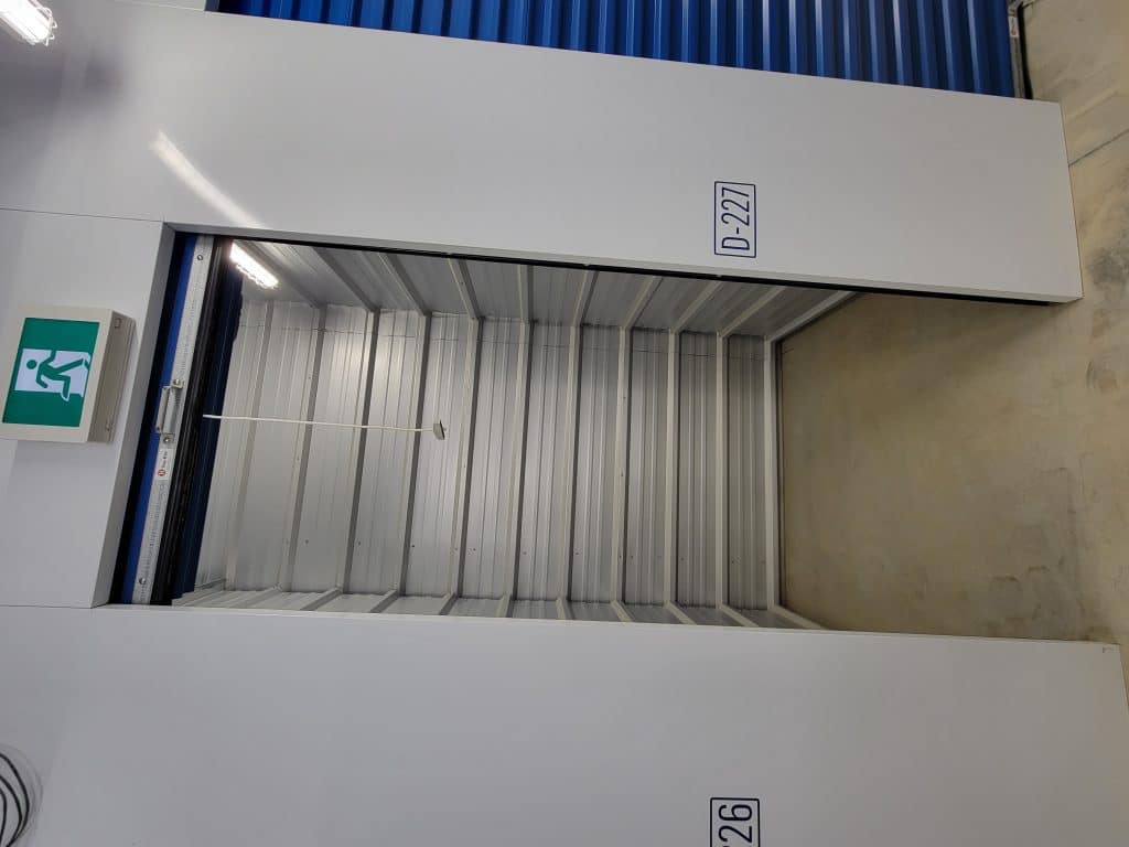 Clean, empty storage unit with roll-up door at All Access Storage Parksville.