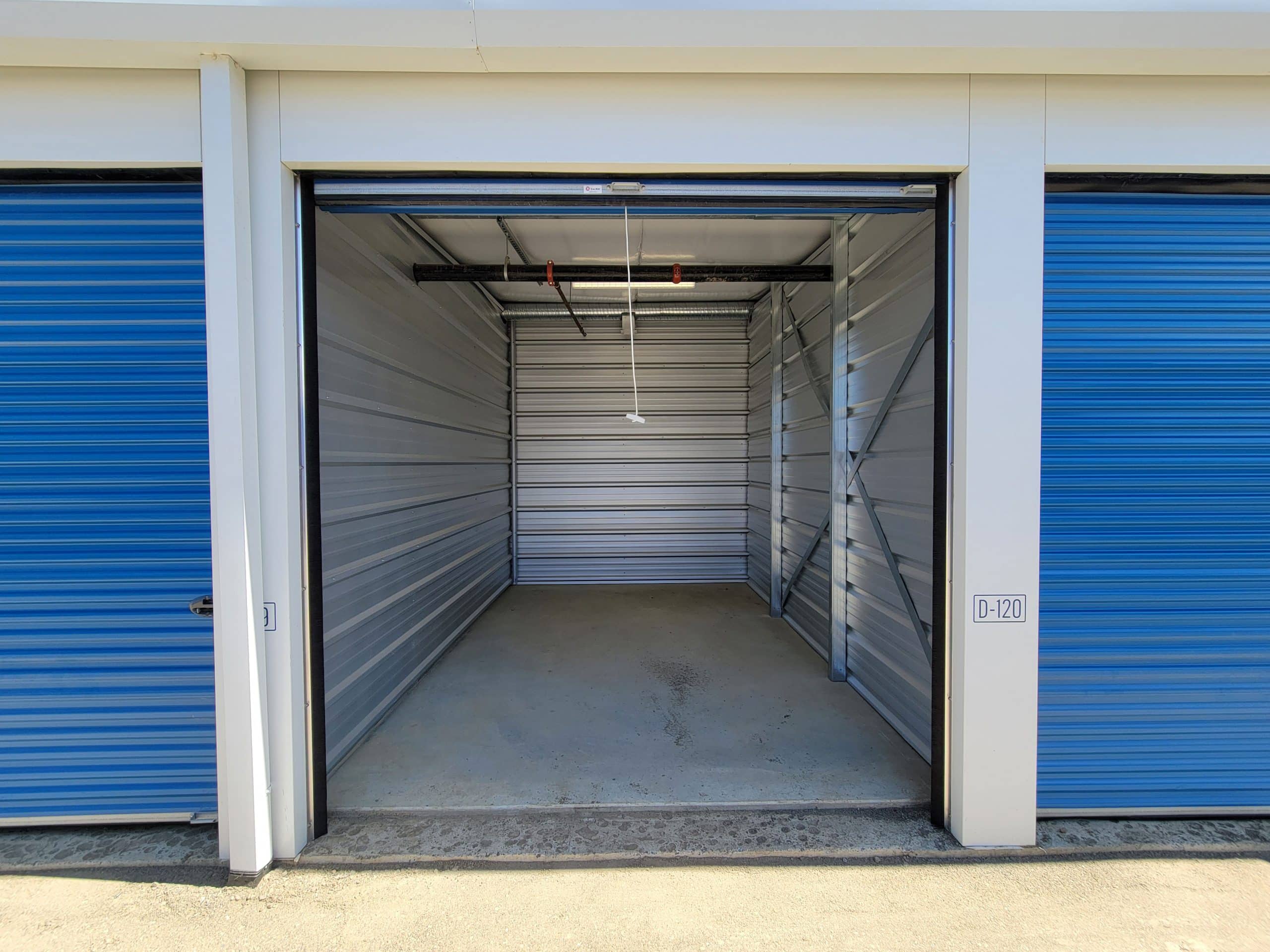 Clean, empty storage unit with roll-up door at All Access Storage Parksville.