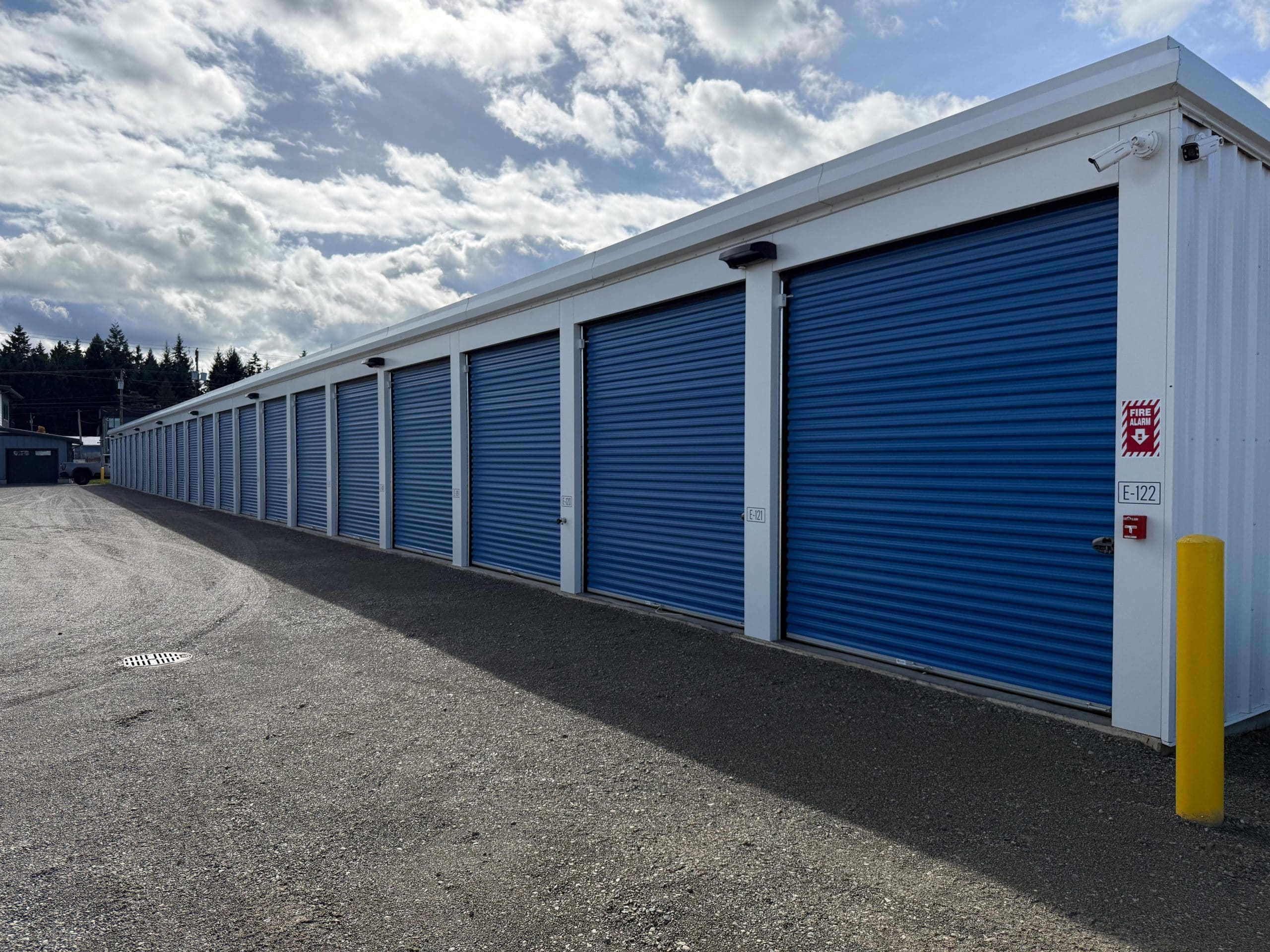 Row of modern self-storage units with roll-up doors in Parksville